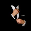 Man in a black suit and white shirt and black tie on a black background. Without a face. The businessman in the dark. Studio shot Royalty Free Stock Photo