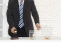 Man in black suite with wooden auction hammer in hand wait to auction the gold fish Royalty Free Stock Photo