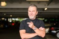 Man with a black T-shirt pointing to the camera Royalty Free Stock Photo