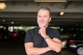 Man with a black T-shirt wears a stylish watch and looking to camera Royalty Free Stock Photo