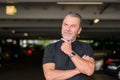 Man with a black T-shirt wears a stylish watch and looking to side Royalty Free Stock Photo