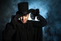 Man in a black top hat and cloak. Demonic image. Magician illusionist Royalty Free Stock Photo