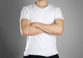 Man in blank white t-shirt. The guy folded his hands on his chest. Isolated Royalty Free Stock Photo