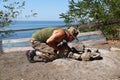 A man blowing a fire on a hike on a camping trip Royalty Free Stock Photo