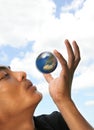 Man blowing spinning globe Royalty Free Stock Photo