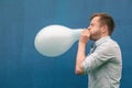 Man blowing up a balloon