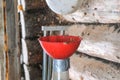 A man blows nuts from small debris using DIY device to extract cedar nuts from Siberian pine cones.