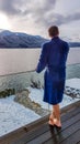 Austria - A young man in a blue bathrobe standing on the balcony in winter