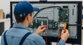 technician testing electronic components inside a television with a multimeter Royalty Free Stock Photo