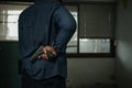 A man in a blue denim shirt was standing behind his back holding a pistol. concept of assassination, murder, criminal