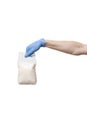 Man in blue gloves holding pack of sugar. bag hold in hand isolated on white Royalty Free Stock Photo