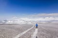 Man on snowy field in kamchatka mountains near covered by snow volcanoes Royalty Free Stock Photo