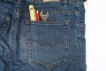 Man blue jeans back pocket with wrench meter and pencil