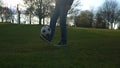 Man In Blue Jeans And Moccasins Juggling Black and White Classic Soccer Ball. People Go In For Sports. Young Boy Playing Royalty Free Stock Photo