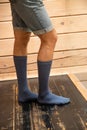 A man in blue long socks on a wooden floor. CLOSE-UP. Vertically