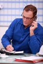 Man in blue overalls speaking Royalty Free Stock Photo