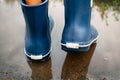 Man in blue rubber boots walking through the puddle Royalty Free Stock Photo