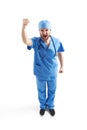 Man in blue scrubs showing his fist