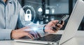 Man using laptop and smartphone with cybersecurity icons Royalty Free Stock Photo