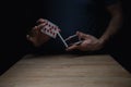 Man Shuffling Deck of Red Cards at Wooden Table Card Tricks Royalty Free Stock Photo