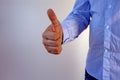 A man in a blue shirt and jeans shows the gesture of approval Royalty Free Stock Photo