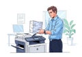 A man in a blue shirt operates a photocopier in an office setting. He is holding a stack of papers. Royalty Free Stock Photo
