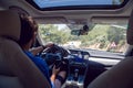 Man in a blue shirt sitting behind the wheel in the car Royalty Free Stock Photo