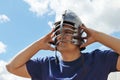 Man in blue shirt wears medieval helmet with leather straps