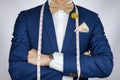 Man in blue suit bowtie, brooch, pocket square blue suit carry m Royalty Free Stock Photo