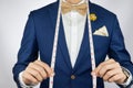 Man in blue suit bowtie, brooch, pocket square blue suit carry m Royalty Free Stock Photo