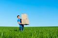 Man in blue t-shirt carrying boxes Royalty Free Stock Photo