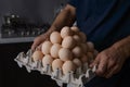 A man holding a full tray of chicken eggs in his own kitchen Royalty Free Stock Photo