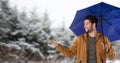 Man with blue umbrella in snow forest Royalty Free Stock Photo