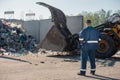 Man looking at garbage at landfill Royalty Free Stock Photo