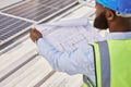 Man, blueprint or engineer on rooftop or construction site for maintenance or architecture outdoor. Inspection, solar Royalty Free Stock Photo