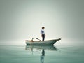 The man is in a boat and admire the lake in the fog Royalty Free Stock Photo