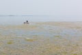 A man in a boat is floating heavily polluted river, The concept of environmental