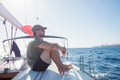 A man in a boat sitting, looking at the ocean, he is thinking. Concept of freedom and carefree