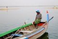 A man with the boat on Taungthaman Lake in Mandalay, Myanmar