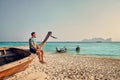 Man on the boat at tropical beach Royalty Free Stock Photo