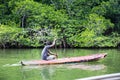 Man in the boat, tropical jungle, Ceylon