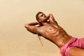 Man Body On Beach. Summer Male Lying On Sand At Resort Royalty Free Stock Photo