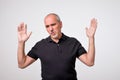 Man body language. I did not do it concept. Mature italian handsome man raising hands up. Royalty Free Stock Photo