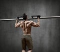 Man - bodybuilder perform exercise chin-up