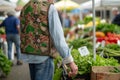 man with boho vest and jeans browsing a farmers market Royalty Free Stock Photo