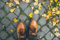 Man boots top view with yellow leaves
