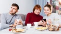 Man bored while wife and mother looking at phones Royalty Free Stock Photo