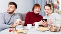 Man bored while wife and mother looking at phones Royalty Free Stock Photo