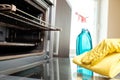 Man with bottle of spray and rag cleaning oven Royalty Free Stock Photo