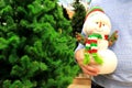 A man bought large funny snowman in the store, a gift for a child for his birthday, Christmas, new year. Christmas shopping in